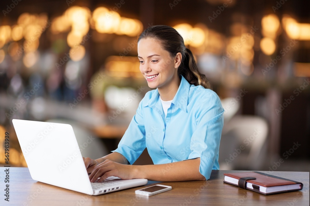Young happy woman sitting with laptop computer Young happy woman sitting with laptop computer