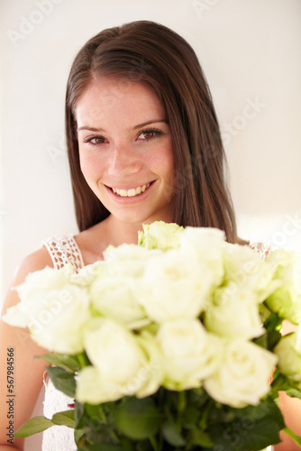 Portrait, woman and bouquet of flowers for celebration, happiness and achievement with smile, gift or beauty. Face, confident female or happy lady with white roses, floral present or romantic gesture