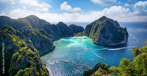 Fototapeta Naklejka Na Ścianę i Meble -  Aerial view of the famous Maya Beach, Phi Phi islands, Thailand, with turquoise sea shining between the lush mountains