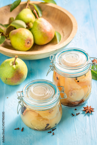 Pickled pears with anise and sugar in jar.