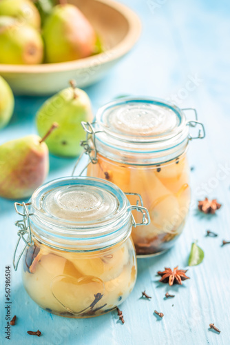 Sweet pickled pears in vinegar with cloves.