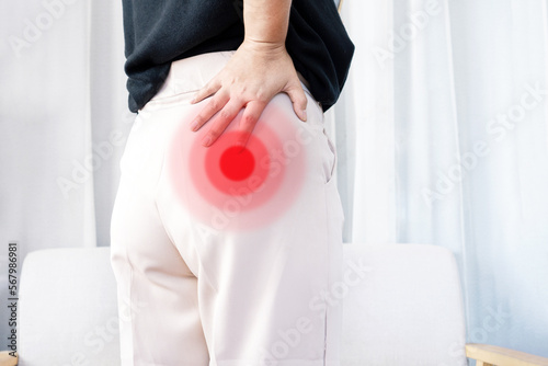 Piriformis syndrome concept with woman suffering from buttock muscle pain when sitting
