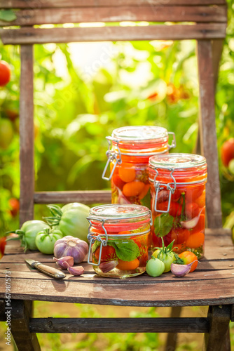 Healthy and tasty pickled tomatoes with vegetables from greenhouse.