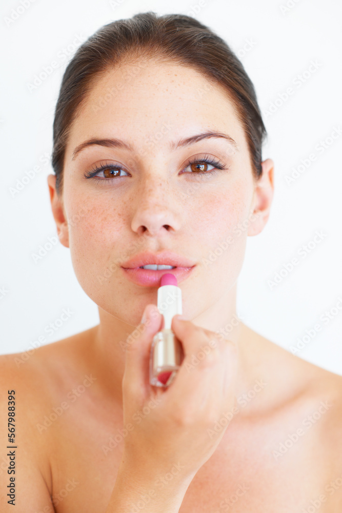Woman, face and lipstick for makeup, cosmetics or skincare isolated against a white studio background. Portrait of beautiful happy female applying cosmetic product on lips for beauty or self love Woman, face and lipstick for makeup, cosmetics or skincare isolated against a white studio background. Portrait of beautiful happy female applying cosmetic product on lips for beauty or self love