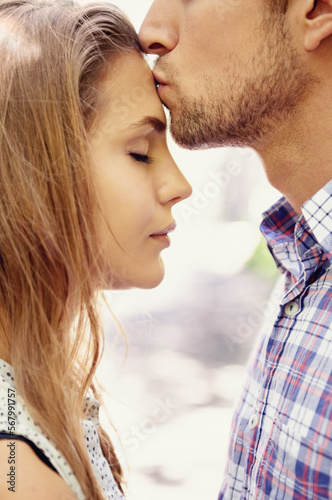 Love, couple and forehead kiss, park and happiness for relationship, dating and quality time outdoor. Romance, man and woman with affection, loving or bonding with romantic gesture or kissing on head