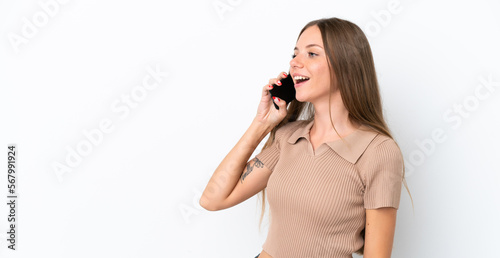 Young Lithuanian woman isolated on white background keeping a conversation with the mobile phone