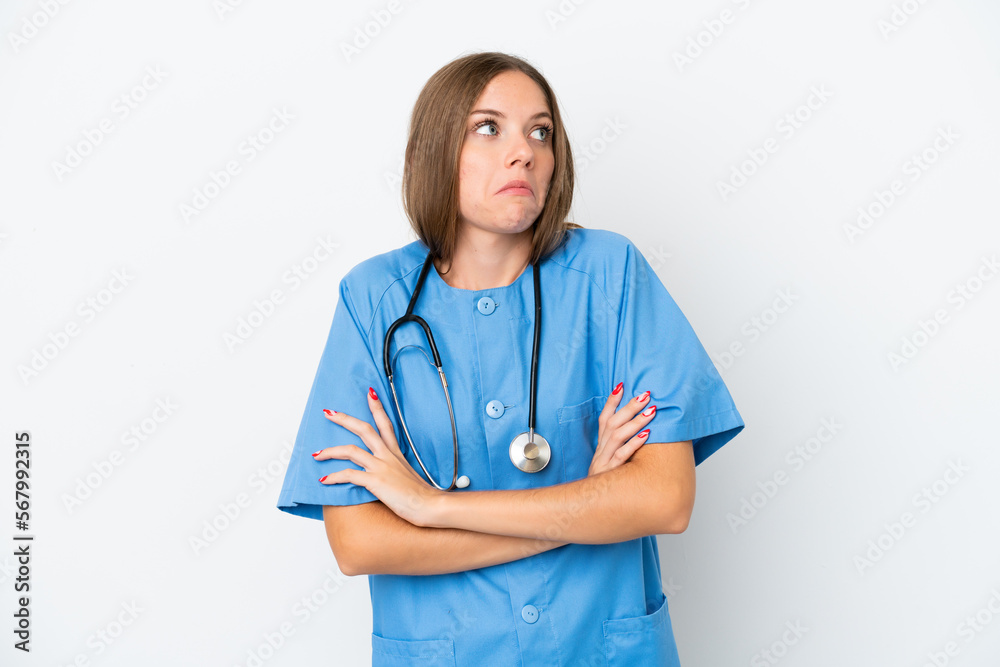 Young surgeon doctor Lithuanian woman isolated on white background making doubts gesture while lifting the shoulders Young surgeon doctor Lithuanian woman isolated on white background making doubts gesture while lifting the shoulders