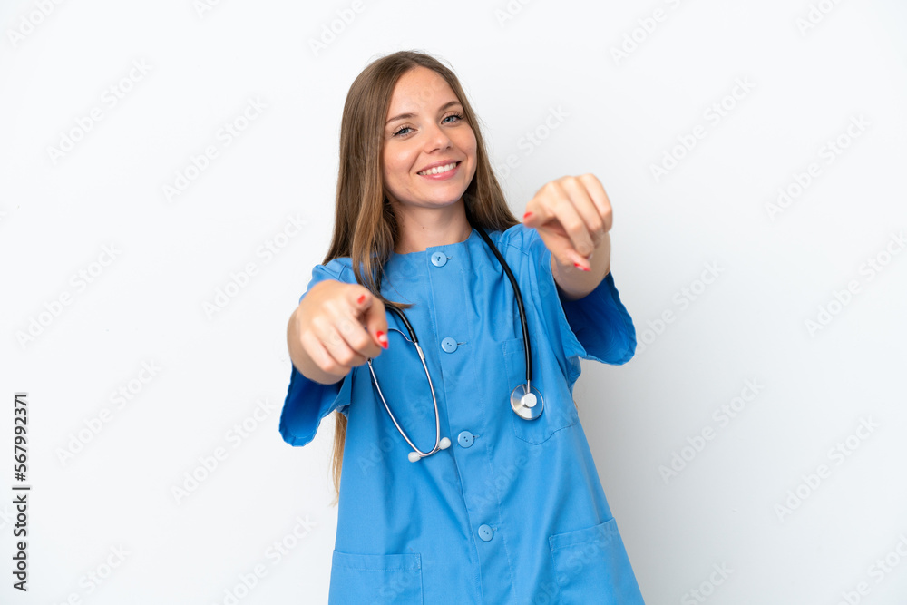 Young surgeon doctor Lithuanian woman isolated on white background points finger at you while smiling Young surgeon doctor Lithuanian woman isolated on white background points finger at you while smiling