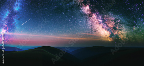 Digital art of milky way and pink light at mountains. Night colorful landscape and starry sky with hills at summer. Beautiful Universe. 