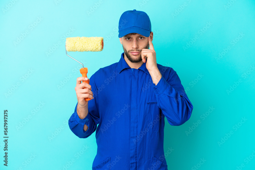 Painter caucasian man isolated on blue background thinking an idea Painter caucasian man isolated on blue background thinking an idea