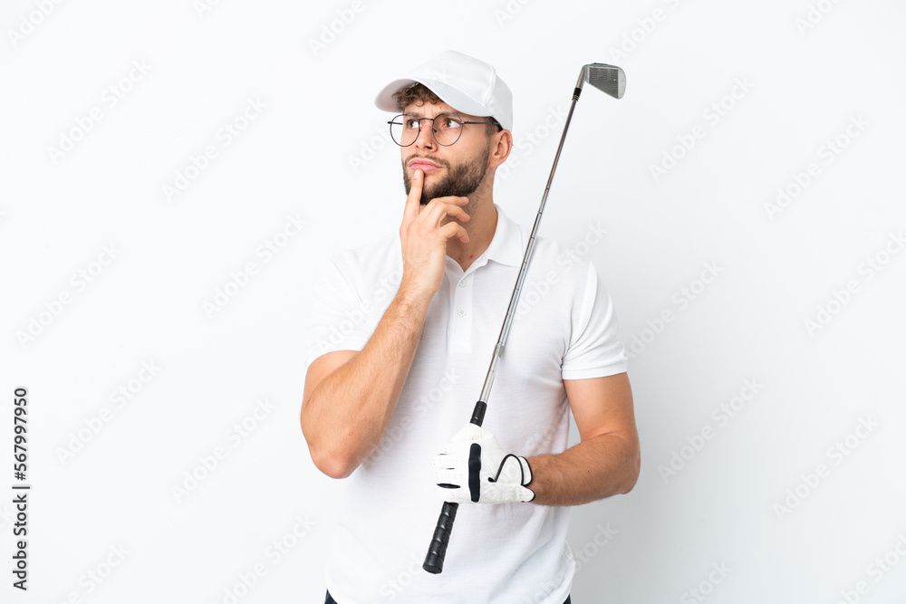 Handsome young man playing golf isolated on white background having doubts while looking up Handsome young man playing golf isolated on white background having doubts while looking up