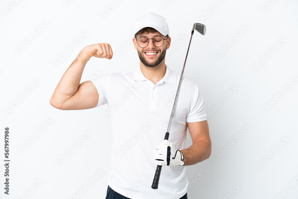Handsome young man playing golf isolated on white background doing strong gesture Handsome young man playing golf isolated on white background doing strong gesture