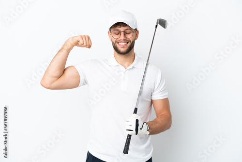 Handsome young man playing golf isolated on white background doing strong gesture