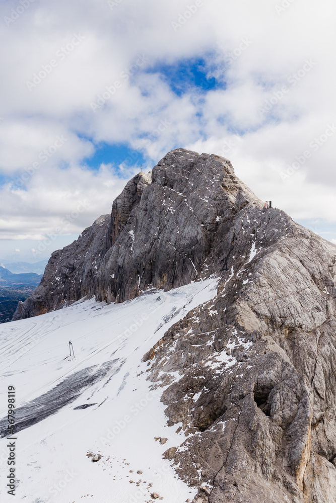 alpine mountain views strewn with snow under a blue sky