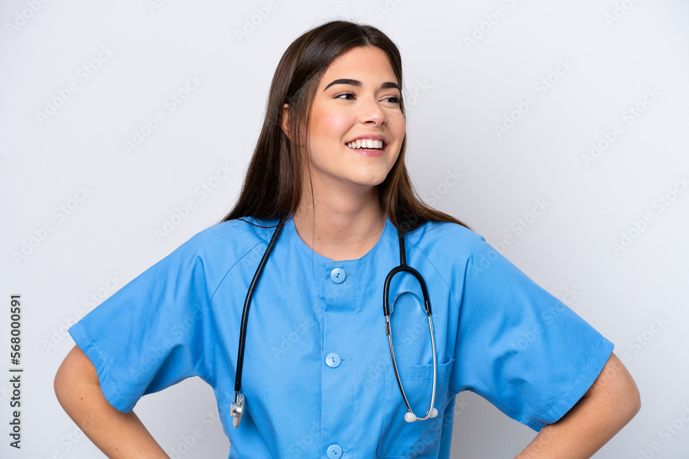 Young Brazilian nurse woman isolated on white background posing with arms at hip and smiling Young Brazilian nurse woman isolated on white background posing with arms at hip and smiling