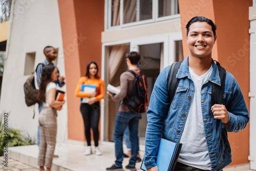 Young hispanic student smiling happy wearing a backpack at the university.