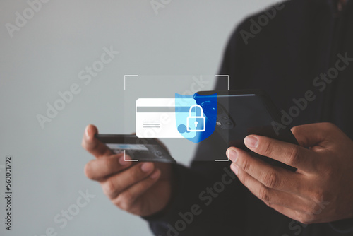 Secure online payment concept. Online shopping and Data encryption. man holding credit card and smartphone doing online banking transaction. E-commerce virtual shopping, secure mobile banking concept.