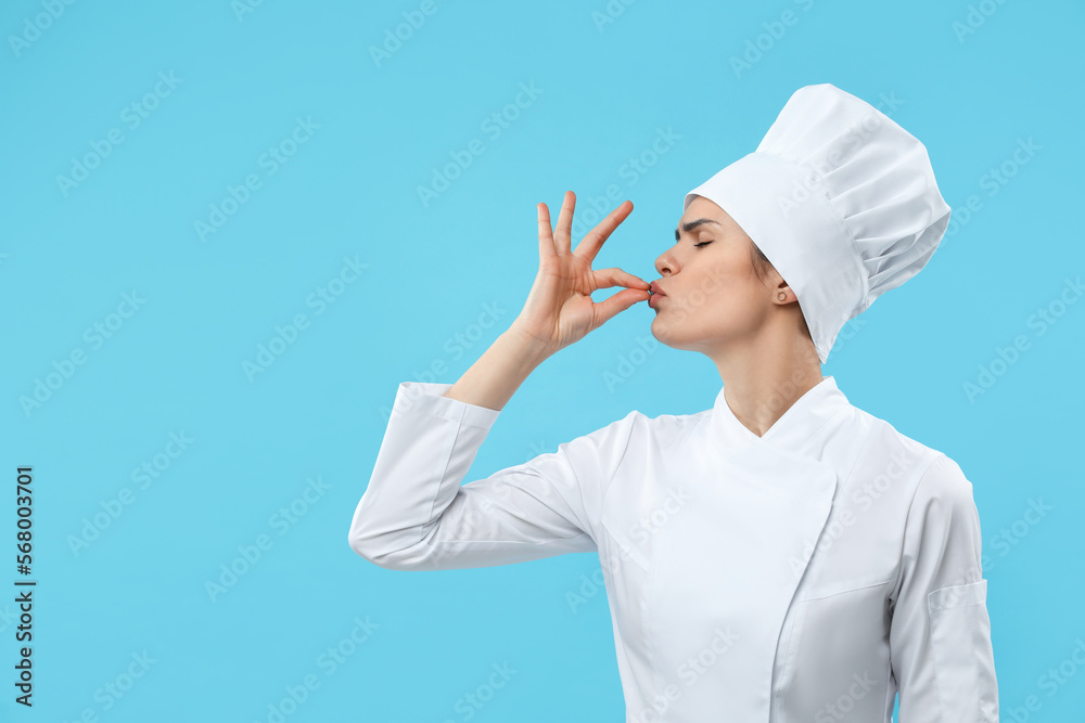 Female chef showing perfect sign on light blue background. Space for text Female chef showing perfect sign on light blue background. Space for text