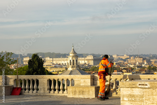 Canvas Print Street cleaners sweeping fallen leaves outdoors on autumn day