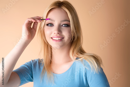 Wallpaper Mural Eyebrow shaping, woman combs eyebrows with a brus. Eyebrow line. Makeup and cosmetology concept. Female model with long eyelashes and thick eyebrows. Perfect shaped brow. Torontodigital.ca