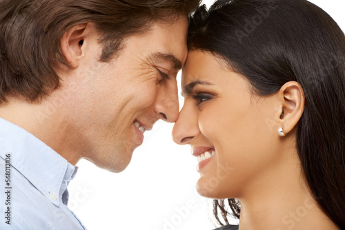 Couple, forehead and smile for love, valentines day or date in affection isolated against white studio background. Closeup of man and woman smiling touching heads embracing special month of romance