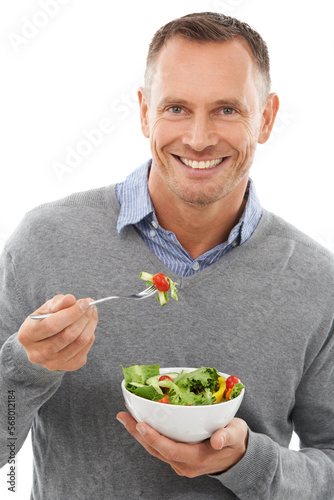 Salad, portrait and man isolated on a white background for healthy green food, diet and nutritionist breakfast. Professional person or model eating vegetables or food for vegan or nutrition in studio
