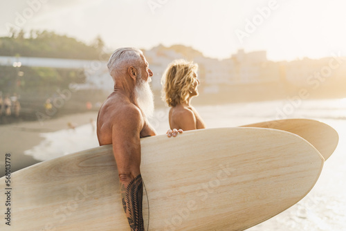 Canvas Print Happy surfers with different ages having fun surfing on tropical beach - Extreme