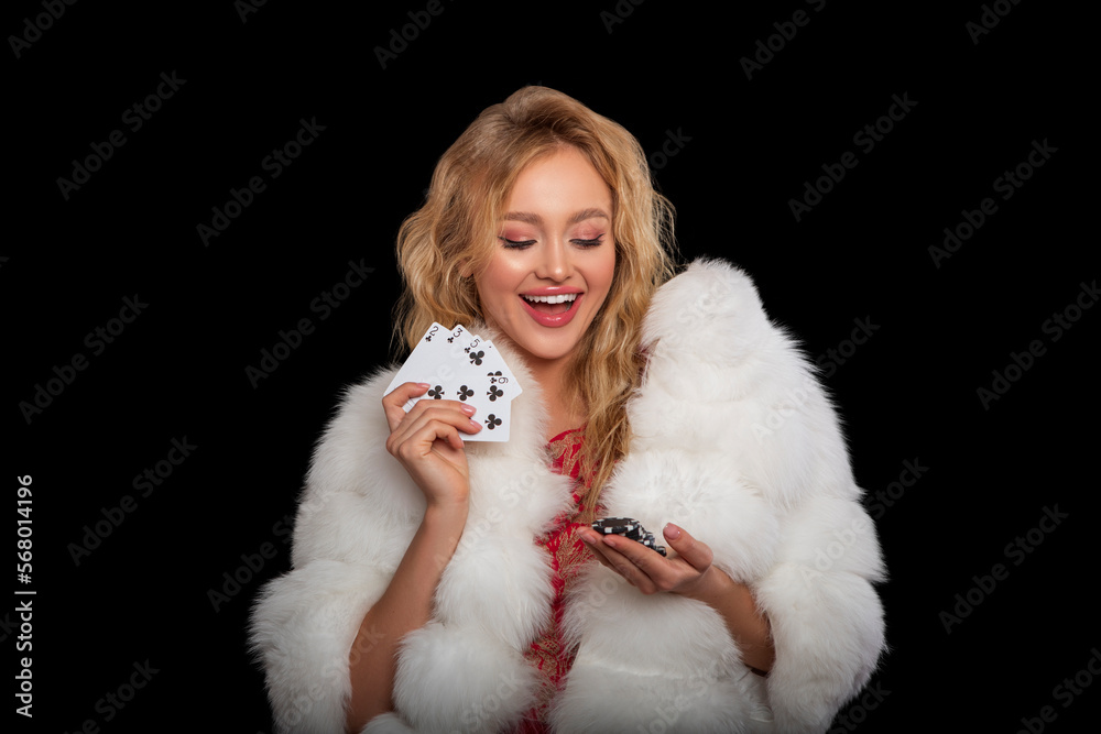 Happy girl playing cards. Lucky Girl with curly hairstyle and perfect make-up is posing with casino chips in her hands. Gambling, successful rye-haired Woman Happy girl playing cards. Lucky Girl with curly hairstyle and perfect make-up is posing with casino chips in her hands. Gambling, successful rye-haired Woman