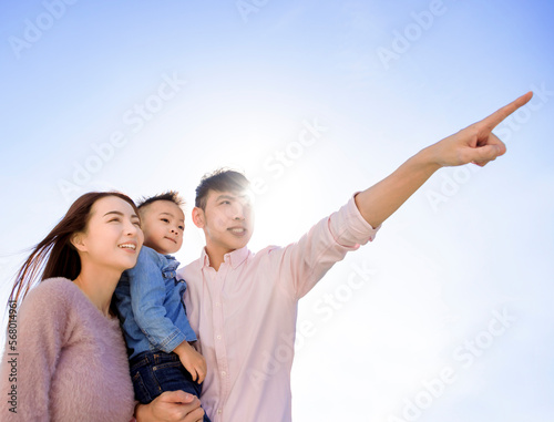 Happy family  standing and looking up © Tom Wang