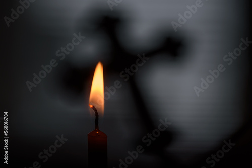 Candle flame with cross shadow