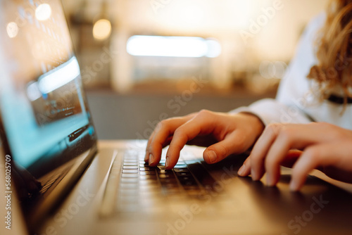 Fotografia, Obraz Female hands working on a laptop, close-up