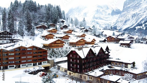 Grindelwald village in Switzerland aerial drone video on snowy day in winter time