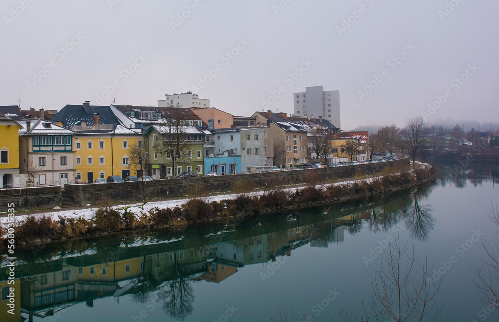 Christmas Eve on the Drava River viewed from the Draubrucke Bridge in the historical centre of Villach, Carinthia, Austria

