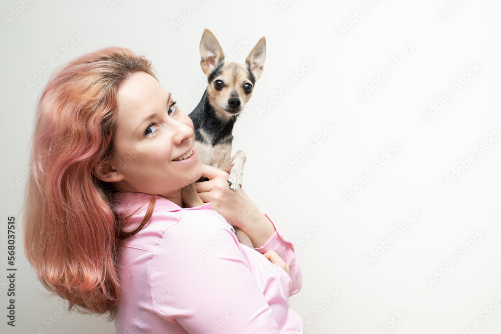 woman with a small dog in her arms, copy space