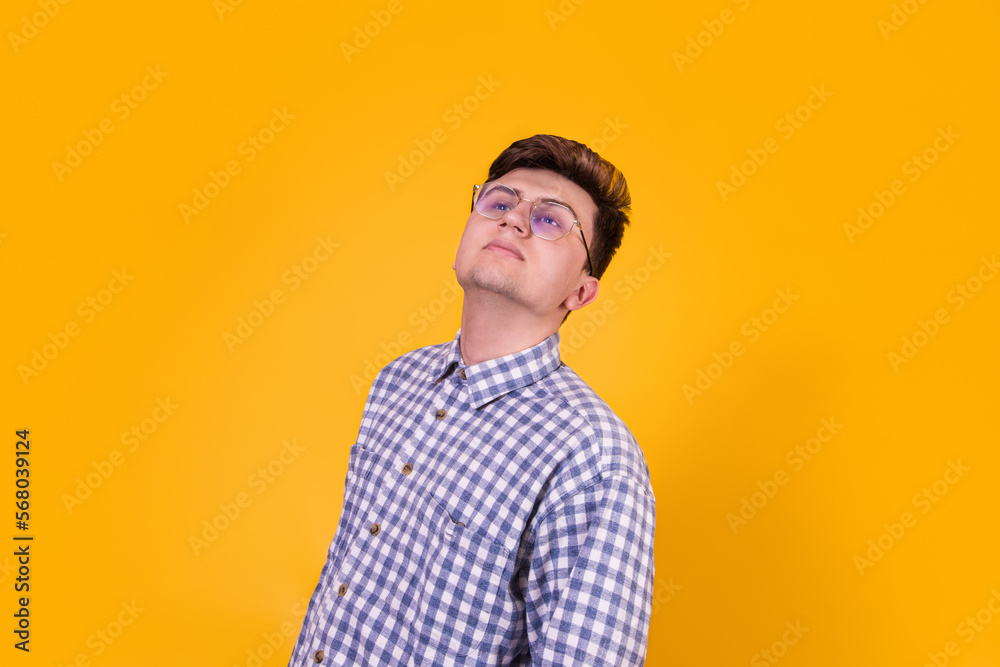 A handsome guy in glasses on a yellow background A handsome guy in glasses on a yellow background