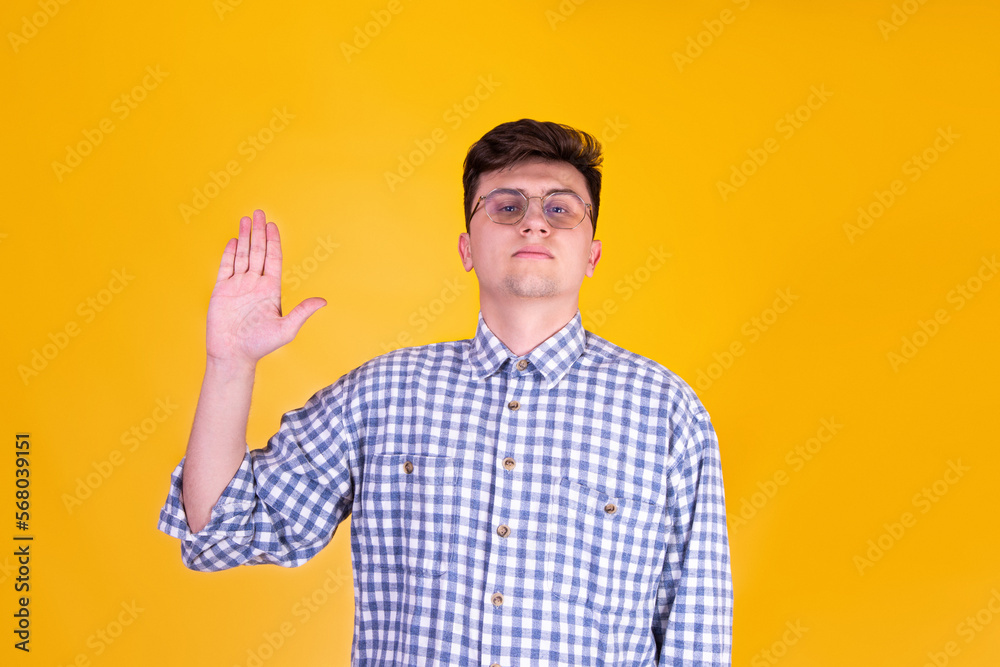 A handsome guy in glasses on a yellow background A handsome guy in glasses on a yellow background