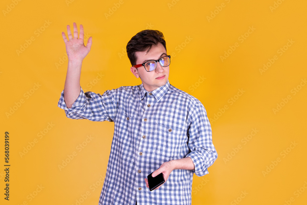 A handsome guy in glasses on a yellow background A handsome guy in glasses on a yellow background