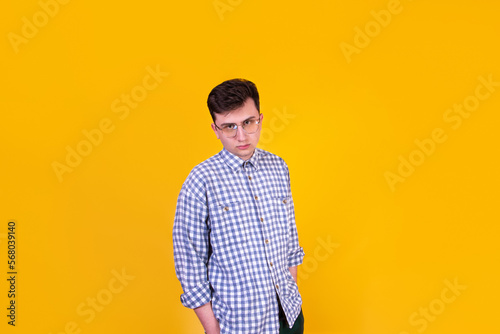 A handsome guy in glasses on a yellow background