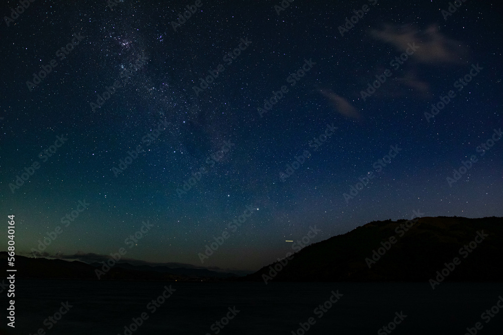 Starry Night Sky over water with Milky Way Galaxy Starry Night Sky over water with Milky Way Galaxy