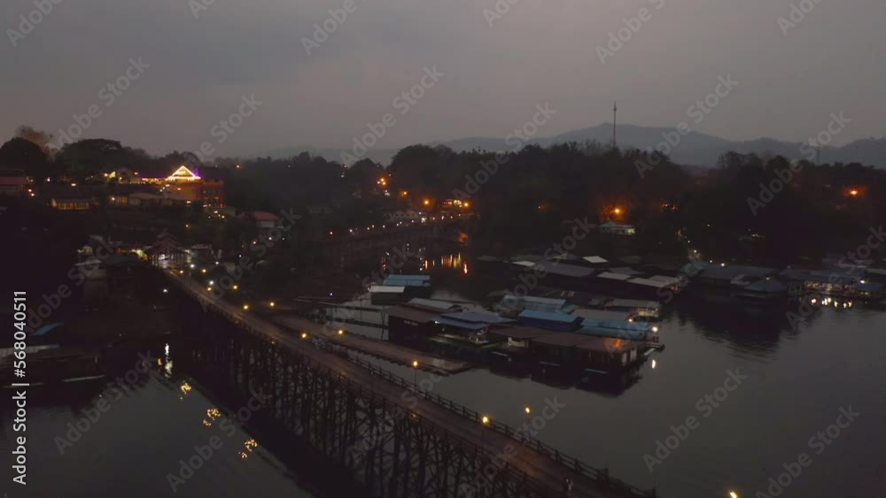 Aerial top view of residential local floating houses in Mon village, nature trees with lake or river, Kanchanaburi, Thailand in urban city town in Asia, buildings. Aerial top view of residential local floating houses in Mon village, nature trees with lake or river, Kanchanaburi, Thailand in urban city town in Asia, buildings.