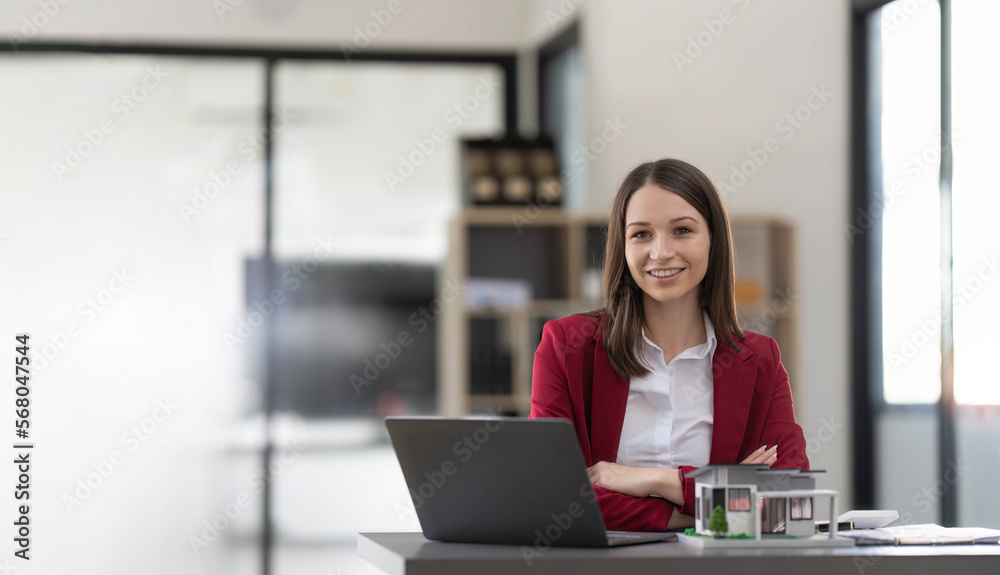 Asian businesswoman making a deal to buy a house or condo inside the office, home insurance concept Asian businesswoman making a deal to buy a house or condo inside the office, home insurance concept