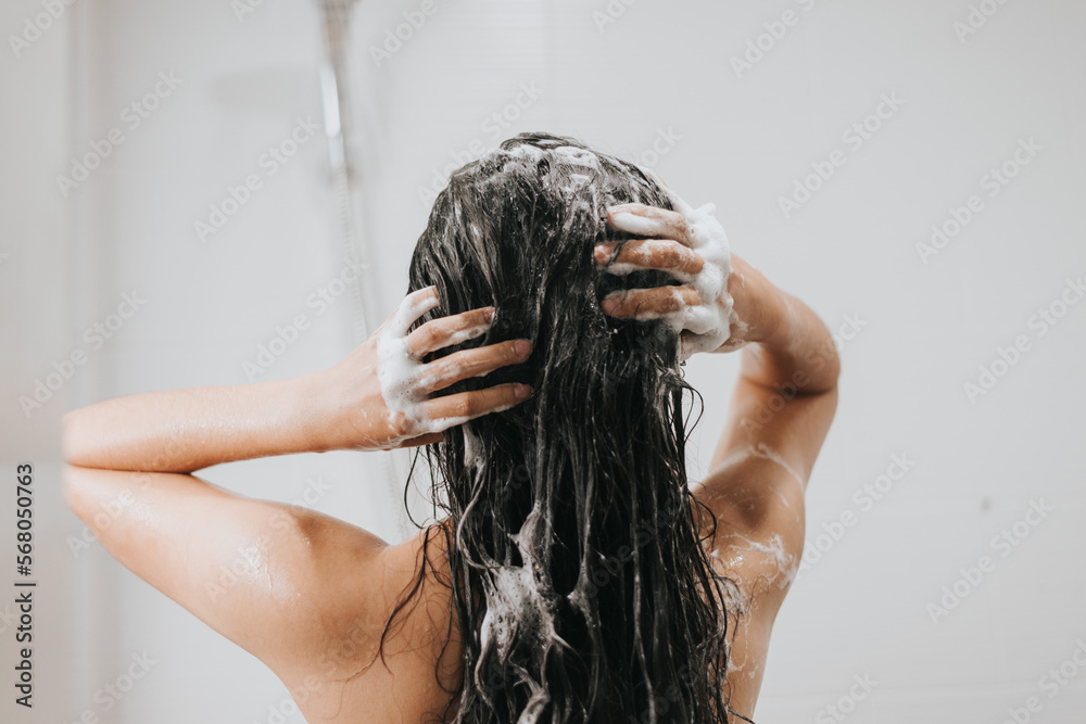 Woman washing hair with shampoo and shower in bathroom, Asian female body and hair care with foam to freshness. Spa and Health care. - obrazy, fototapety, plakaty 