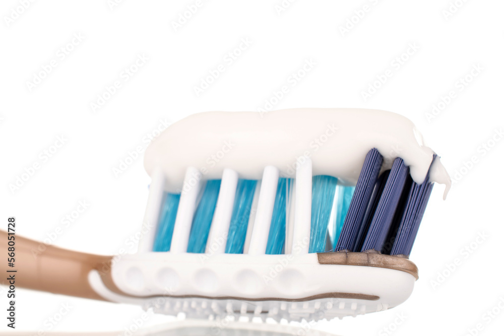 Oral care products, one toothbrush with toothpaste, macro, isolated on white background. Oral care products, one toothbrush with toothpaste, macro, isolated on white background.