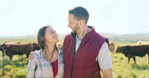Cow, love and happy couple on a cattle farm hugging, bonding and enjoy quality time outdoors in nature. Smile, portrait and woman farming cows and harvesting animal livestock with a farmer on field