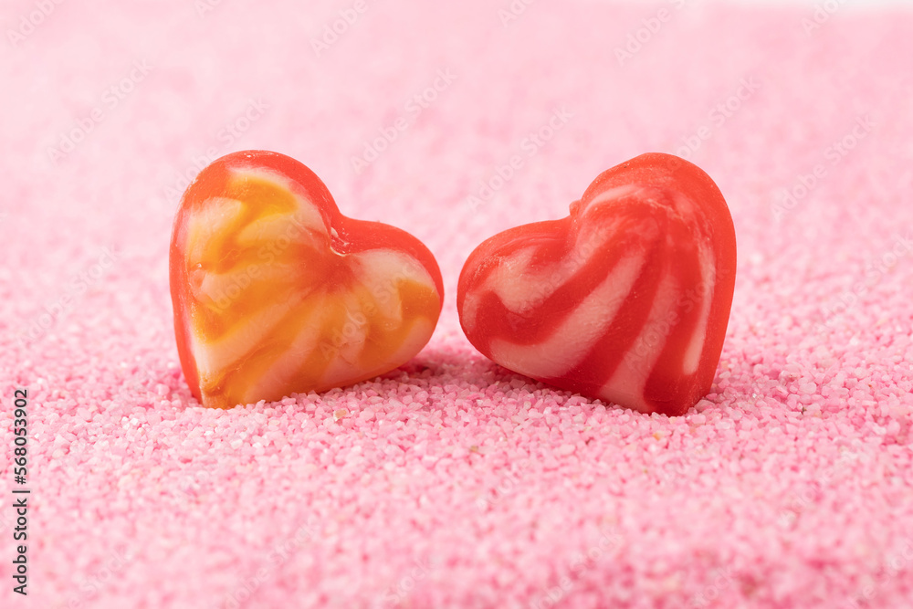 Heart-shaped candy bars in the pink sand