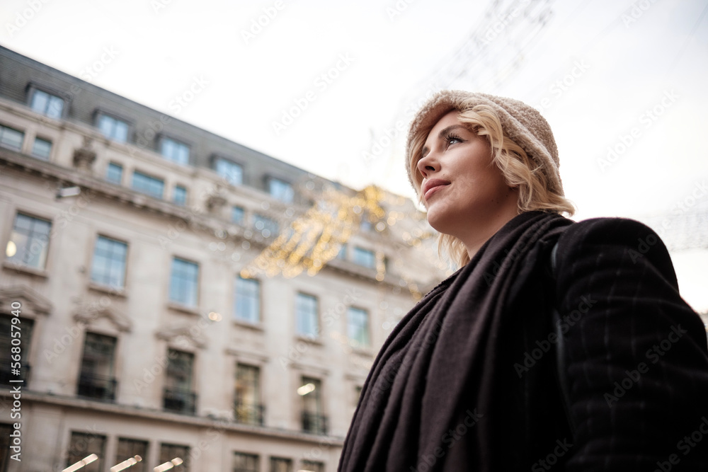 Portrait of young woman posing in Regent Street in London.