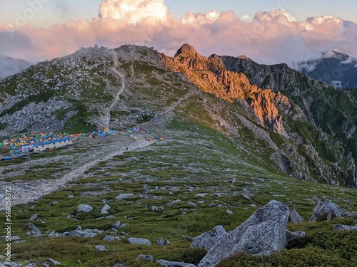 Mt. Hoken lit by the setting sun seen from Mt. Kisokomagatake in the Central Alps. Miyata Village, Nagano Prefecture, Japan in July. photo