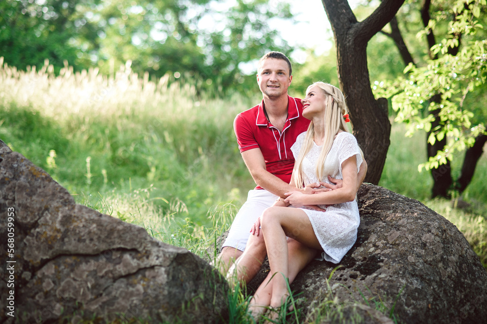 couple in love at a picnic in a park with green grass couple in love at a picnic in a park with green grass