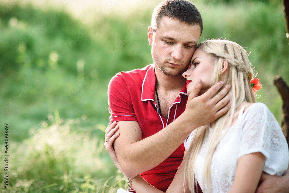 Fototapeta premium couple in love at a picnic in a park with green grass