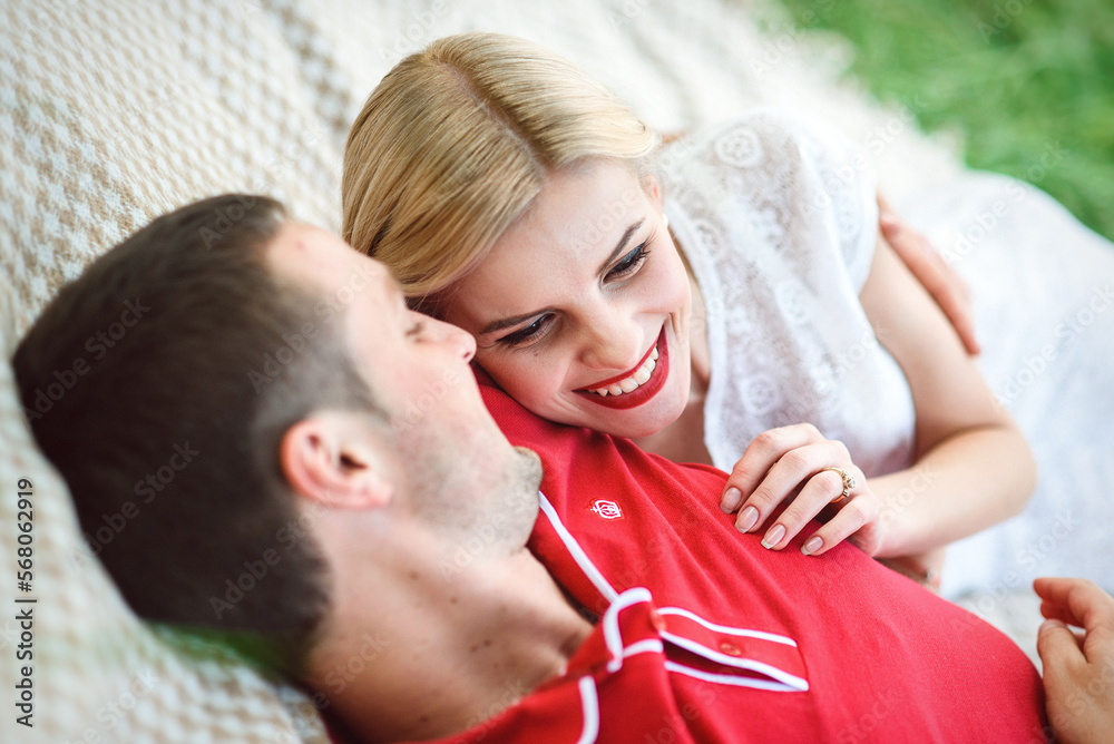 couple in love at a picnic in a park with green grass couple in love at a picnic in a park with green grass